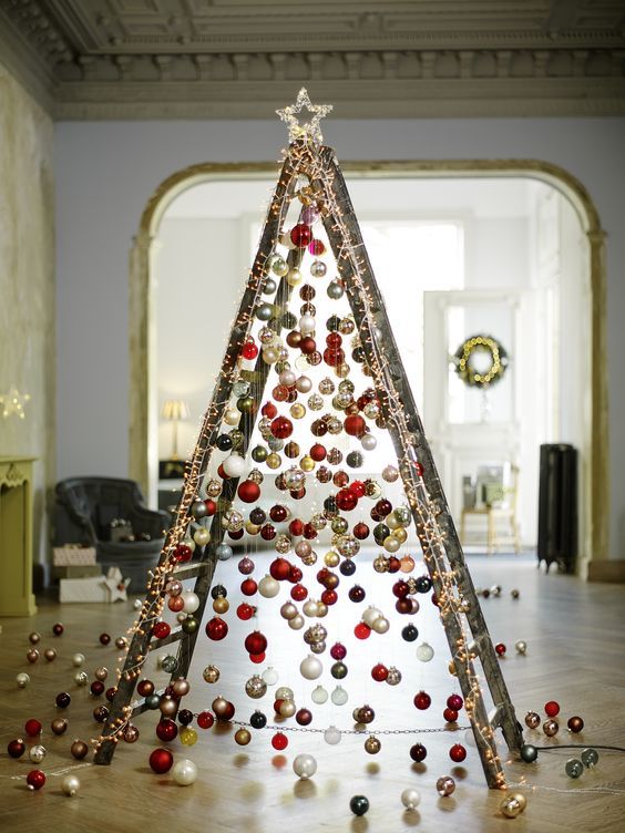  28 take a usual ladder and cover it with lights then attach Christmas ornaments on various heights to form a creative tree